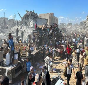 غزة - آلاف المواطنين يتزاحمون على شاحنات المساعدات التابعة لبرنامج الأغذية العالمي بعد دخولها مدينة خان يونس عبر معبر كرم أبو سالم